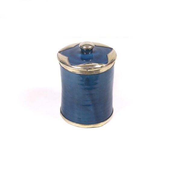 enamelled pottery box surrounded by silver metal