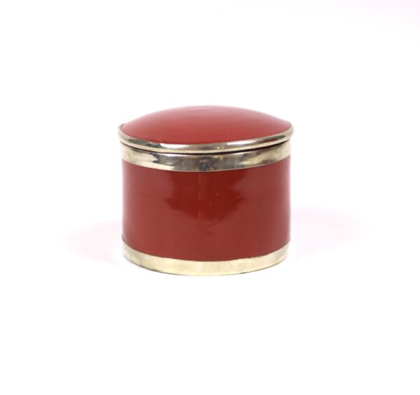 enamelled pottery box surrounded by silver metal